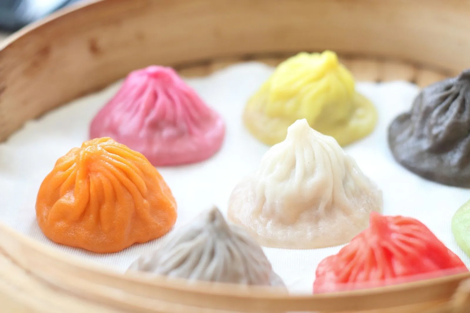 Colorful steamed buns in bamboo steamer at Dumpling Bay, a Chinese Restaurant in Golden